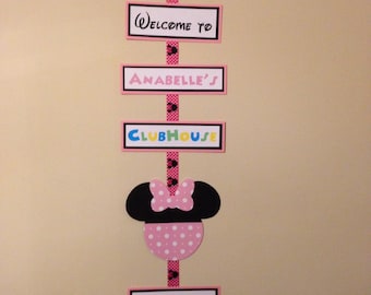 May include: A pink and black Minnie Mouse themed party decoration with the text "Welcome to Anabelle's Clubhouse, Come Inside, It's Fun Inside".