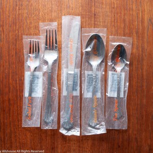 Estia Dorian stainless place setting, with original wrappers and in excellent condition, five-piece setting