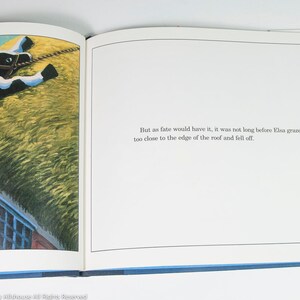 May include: An open book illustration featuring a black and white cow on a thatched roof. The cow is wearing a harness. The text reads: "But as fate would have it, it was not long before Elsa grazed a little too close to the edge of the roof and fell off."