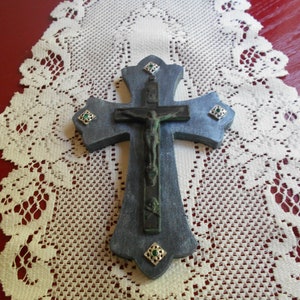 Metal crucifix on wooden cross