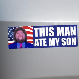 May include: A rectangular bumper sticker with the text "THIS MAN ATE MY SON" in white letters on a blue background. The sticker features an image of a man with an American flag background.