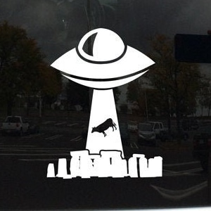 May include: A white vinyl sticker of a UFO abducting a cow. The UFO is hovering over a city skyline. The sticker is on a car window.