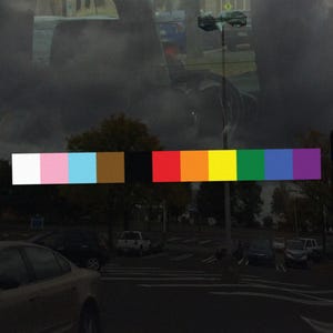 May include: A row of ten colorful squares, including white, pink, light blue, brown, black, red, orange, yellow, green, and purple. The squares are arranged horizontally and are all the same size.