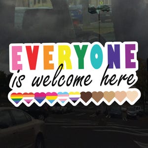 May include: A colorful sticker with the text "EVERYONE is welcome here" in rainbow letters. The sticker features a row of hearts in various colors and skin tones.