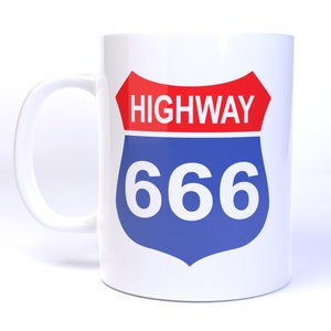 May include: White ceramic mug with a blue and red highway sign featuring the number 666.
