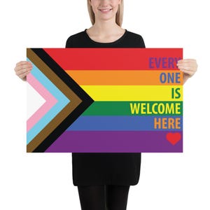 May include: A poster featuring the Progress Pride flag design with the text "EVERYONE IS WELCOME HERE" in purple, orange, and green. The flag includes the traditional rainbow colors, plus the trans flag colors, brown, and black.