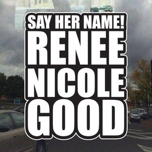 May include: A black and white sticker with the text "SAY HER NAME!" above "RENEE NICOLE GOOD". The sticker has a white border and is set against a blurred background of cars and a cloudy sky.