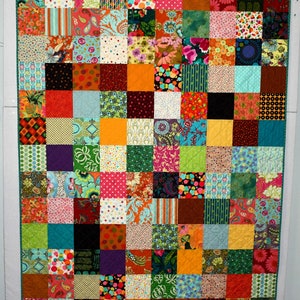 May include: A colorful patchwork quilt with a variety of patterns and colors, including red, orange, yellow, green, blue, purple, and brown.