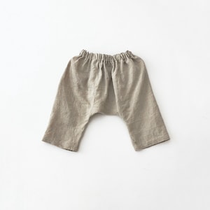 May include: A pair of beige linen trousers with an elastic waistband.