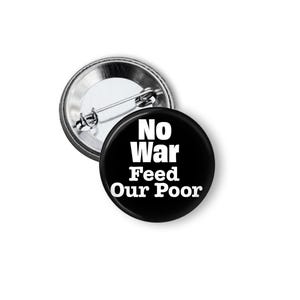 May include: Two round black buttons with the text "No War Feed Our Poor" in white. One button is face up, and the other is face down, showing the pin back. The buttons are on a white background.