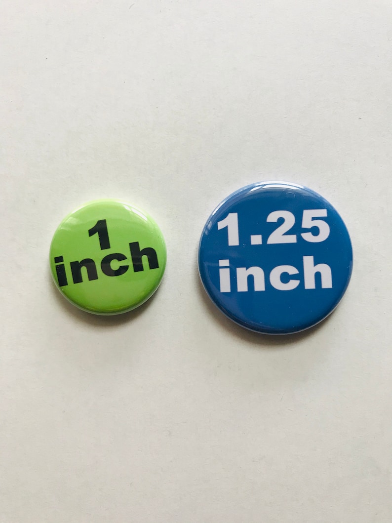Peut inclure: Deux boutons ronds, un vert et un bleu. Le bouton vert indique "1 pouce" en texte noir. Le bouton bleu indique "1,25 pouce" en texte blanc.
