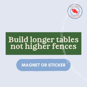 May include: A rectangular green sticker or magnet featuring the white text "Build longer tables not higher fences" with a smaller blue rounded rectangular label below it reading "MAGNET OR STICKER" and a circular logo with a red fish icon.
