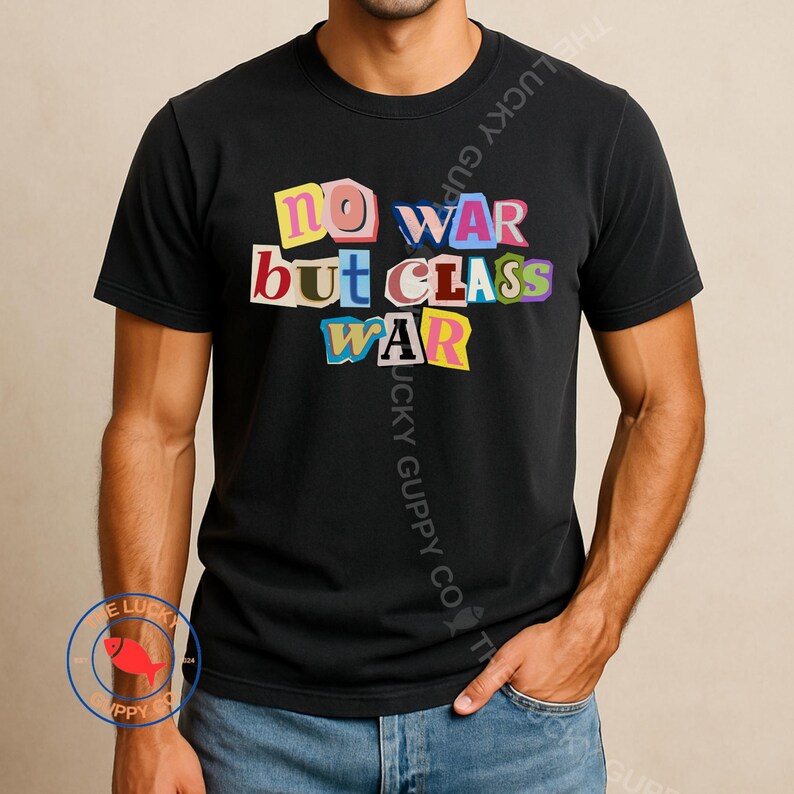 May include: Black t-shirt with the text "NO WAR but CLASS WAR" in colorful, cut-out style letters. The shirt is a crew neck and short-sleeved.