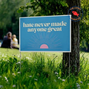 hate never made anyone great yard sign, support trans kids, gender is fluid, protect the dolls flag, girls gays they, trans lives matter