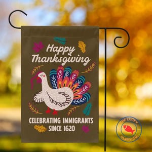 May include: A brown Thanksgiving garden flag with a turkey illustration and the text "Happy Thanksgiving Celebrating Immigrants Since 1620". The turkey has a colorful tail and is surrounded by fall leaves.
