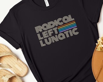 May include: Black t-shirt with the text "RADICAL LEFT LUNATIC" in a retro font with rainbow stripes.