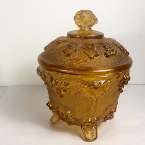 Vintage amber glass grapes and leaves repousse footed candy dish.