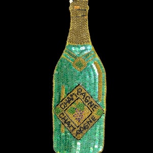 May include: A green and gold sequined champagne bottle with a label that reads "Chantypagne" and a grape design.