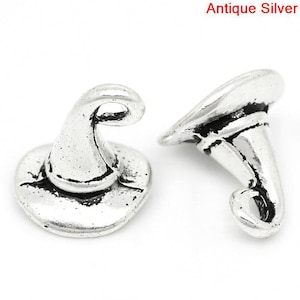 May include: Two antique silver witch hat charms. The charms are detailed with a pointed hat and a curled brim.