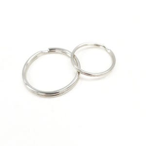 May include: Two silver key rings, one larger than the other, are linked together. The rings are smooth and shiny.