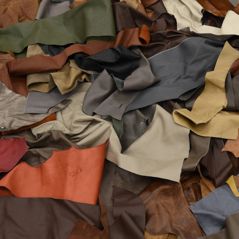 May include: A pile of various colored leather scraps, some with the word "scrap" written on them.