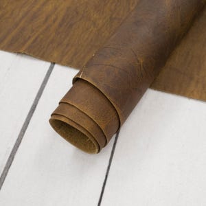 May include: A roll of brown leather with a textured surface.