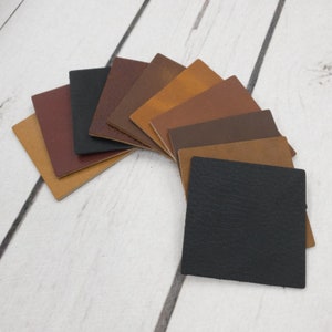 May include: A variety of leather swatches in different shades of brown, tan, and black. The swatches are arranged in a semi-circle, with the darkest shade at the bottom and the lightest shade at the top.