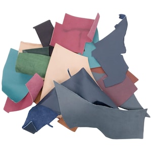 May include: Assortment of leather scraps in various colors, including teal, green, brown, beige, navy, and burgundy. The leather pieces are cut into different shapes and sizes.