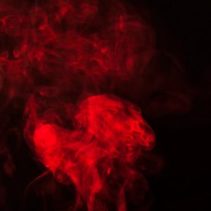 May include: Red smoke billowing against a black background. The smoke forms abstract shapes and patterns.
