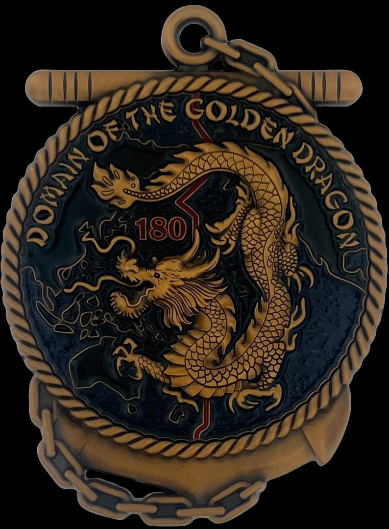 May include: A bronze-colored medallion with the text "DOMAIN OF THE GOLDEN DRAGON" and a golden dragon design. The number "180" is in red. The medallion has an anchor and chain design.