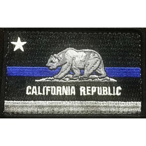 May include: Black and white embroidered patch with a blue stripe. The patch features a white star, a bear, and the text "CALIFORNIA REPUBLIC".