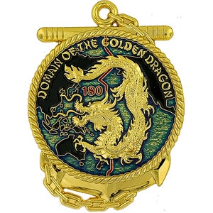 May include: A gold-colored medallion with a detailed dragon design at the center, surrounded by the text "DOMAIN OF THE GOLDEN DRAGON" and the number "180". The medallion has a rope-like border and an anchor at the bottom, with a chain and a bar at the top.