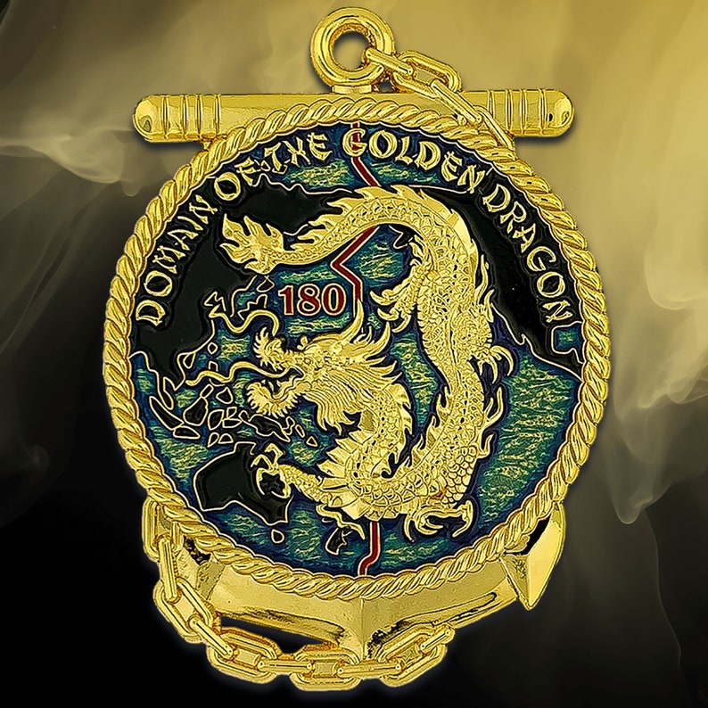 May include: A gold-colored medallion with the text "DOMAIN OF THE GOLDEN DRAGON" and a detailed golden dragon design. The medallion features an anchor and chain design, with the number "180" in red.