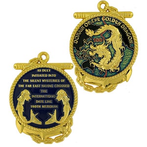 May include: Two gold-colored medallions with intricate designs. One features a golden dragon and the text "DOMAIN OF THE GOLDEN DRAGON 180". The other has two mermaids and the text "AS DULY INITIATED INTO THE SILENT MYSTERIES OF THE FAR EAST HAVING CROSSED THE INTERNATIONAL DATE LINE 180TH MERIDIAN".