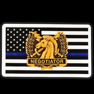 May include: A black and white American flag with a blue stripe across the middle. The flag has a gold badge with a horse head and the word "NEGOTIATOR" on it.