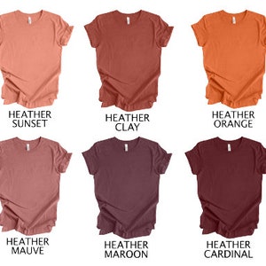 May include: Six heathered t-shirts in various colors: sunset, clay, orange, mauve, maroon, and cardinal. Each shirt has a crew neck and short sleeves. The text "HEATHER" is above each color name.