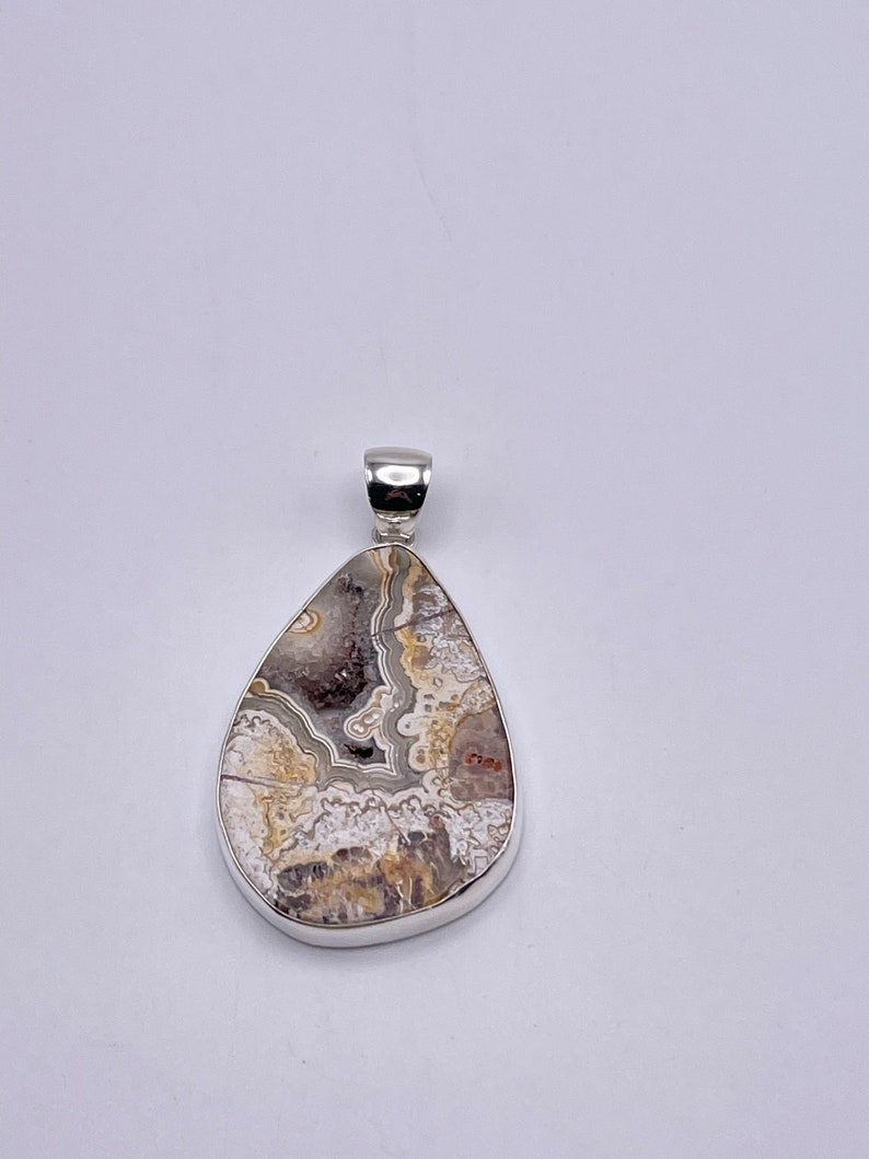 Charles shops Albert Crazy Lace Agate Teardrop Cabochon Pendant set in Fine Sterling Silver with Visible Druzy