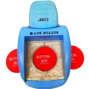 May include: Blue plastic button maker with a red circle that says "BUTTON BOY" and the phone number "702-547-6110". The maker has a handle on top that says "2.088" and a label that says "BUTTON BOY INC."