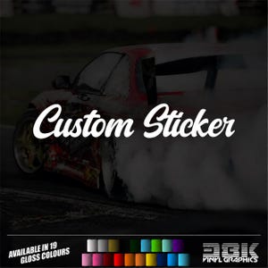 May include: A custom sticker featuring a red sports car drifting on a track with thick white tyre smoke. The text Custom Sticker is displayed in white script. Below, a colour palette shows 19 available gloss colours and the DGK Vinyl Graphics logo.