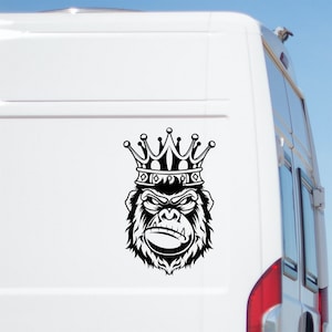 May include: Black and white illustration of a gorilla wearing a gold crown. The gorilla has a serious expression and is looking directly at the viewer.