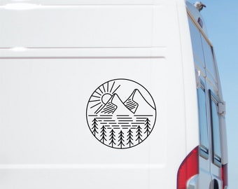 May include: Black and white line art sticker of a mountain range with a sun, lake, and pine trees in a circle. The sticker is on the side of a white van.