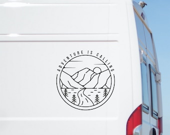 May include: A white van with a black and white sticker on the side that says "Adventure is Calling" with a mountain and river design.