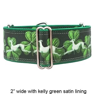 May include: A 5.08 cm wide dog collar featuring a dark green background with a repeating pattern of white greyhound silhouettes and green shamrocks. The collar includes a silver metal rectangular slide adjuster and a kelly green satin lining.