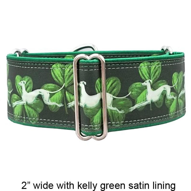 May include: A 5.08 cm wide dog collar featuring a dark green background with a repeating pattern of white greyhound silhouettes and green shamrocks. The collar includes a silver metal rectangular slide adjuster and a kelly green satin lining.