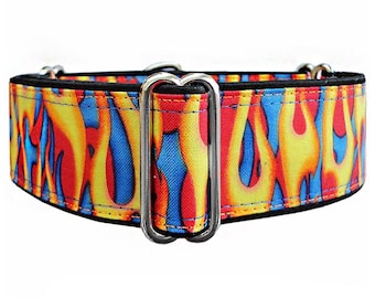 May include: A wide pet collar featuring a vibrant flame pattern in shades of red, yellow, and blue. The collar is constructed with black trim and includes a silver-toned metal rectangular adjustment slider and a D-ring for attachment purposes.