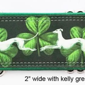 May include: A 5.08 cm wide dog collar featuring a repeating pattern of white greyhound silhouettes running across a dark background with vibrant green shamrocks. The collar includes silver-toned metal hardware and a kelly green satin lining.