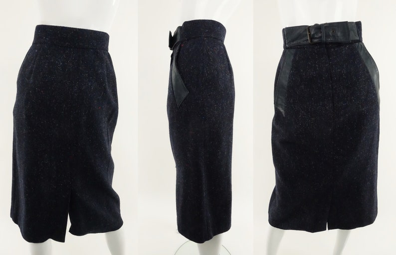 May include: A black skirt with a speckled pattern and a black leather belt. The skirt has a back slit and leather panels on the sides.