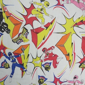 May include: White fabric with a repeating pattern of Power Rangers characters in action poses. The design includes red, yellow, pink, blue, and black figures, along with lightning bolts and the Power Rangers logo.
