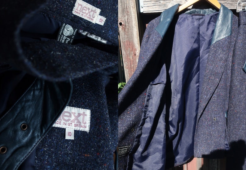 May include: A navy blue tweed blazer with leather trim. The blazer has a double breasted closure and a patch pocket on the left side. The inside of the blazer is lined with a navy blue fabric. The label on the blazer reads "Next" and "Real Leather Trims".