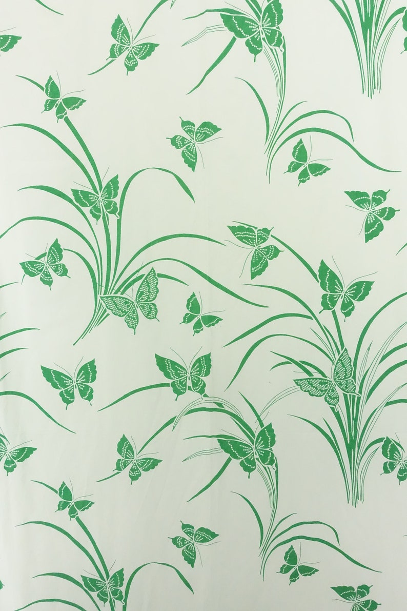May include: A white background with a repeating pattern of green butterflies and green blades of grass.